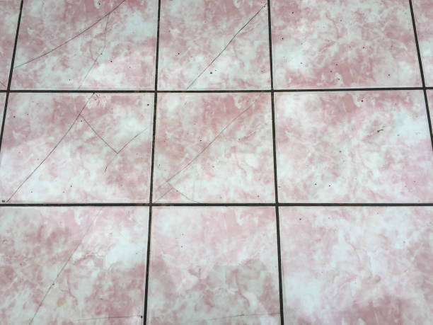 Old and dirty ceramics tile background. High angle view tiled floor